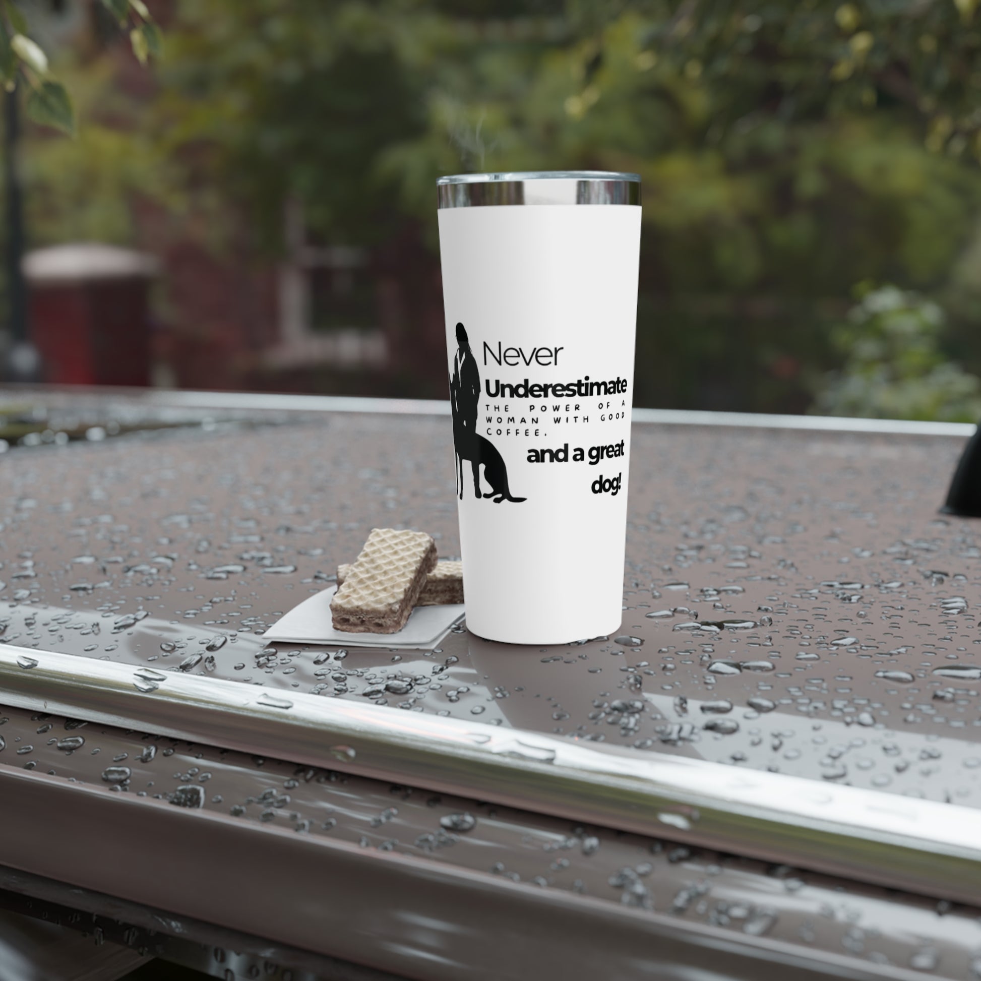Tumbler with motivational quote on a wet surface outdoors